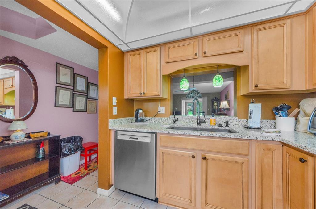 2119 Elm Street, Unit 103 Dunedin, FL 34698 - Photo 22 of 69 a kitchen with stainless steel appliances granite countertop a sink and cabinets