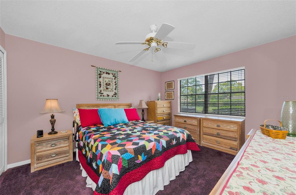 2119 Elm Street, Unit 103 Dunedin, FL 34698 - Photo 25 of 69 a bedroom with a bed and wooden floor