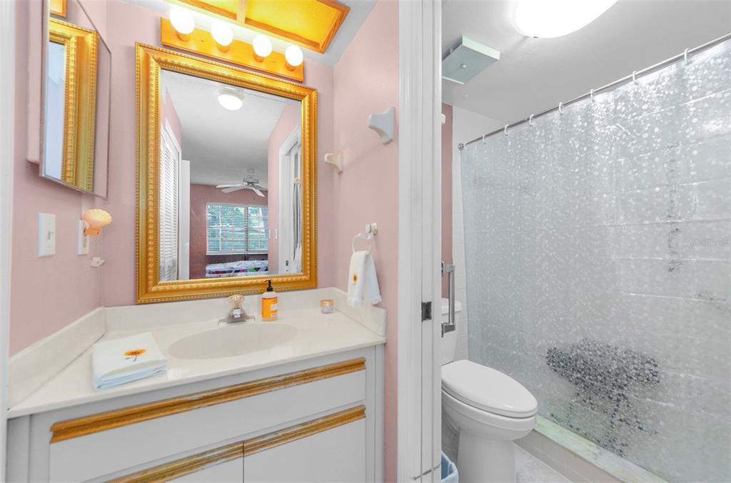 2119 Elm Street, Unit 103 Dunedin, FL 34698 - Photo 28 of 69 a bathroom with a sink and a mirror