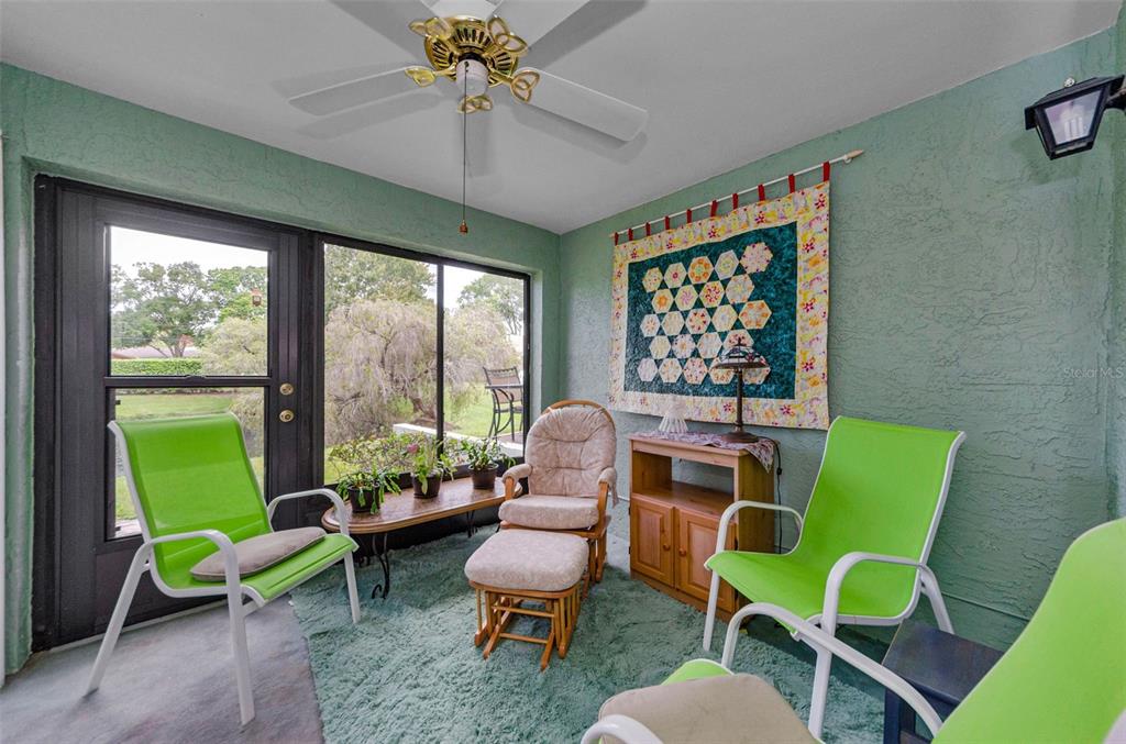 2119 Elm Street, Unit 103 Dunedin, FL 34698 - Photo 33 of 69 a living room with furniture and a large window