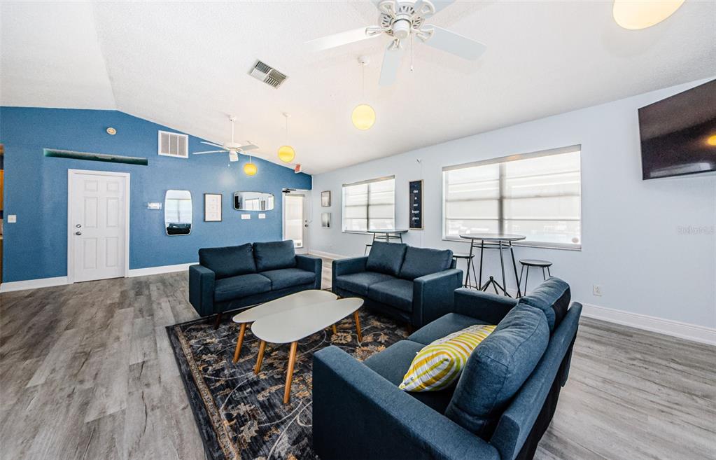 2119 Elm Street, Unit 103 Dunedin, FL 34698 - Photo 41 of 69 a living room with furniture and a flat screen tv