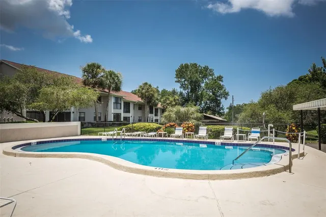 a view of a house with backyard and sitting area