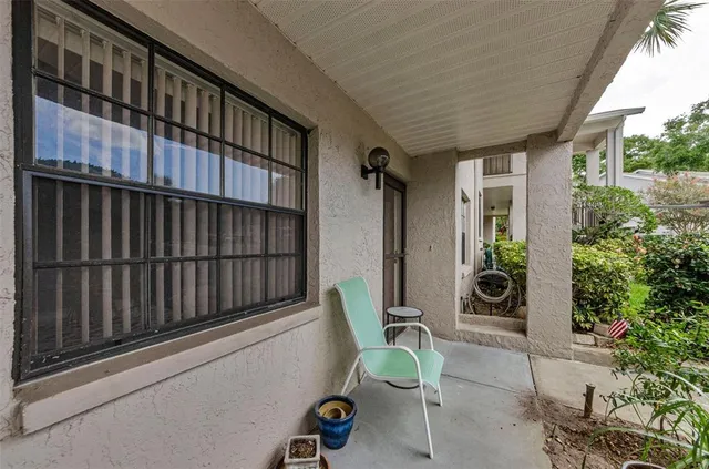 a living room with furniture a flat screen tv and a window