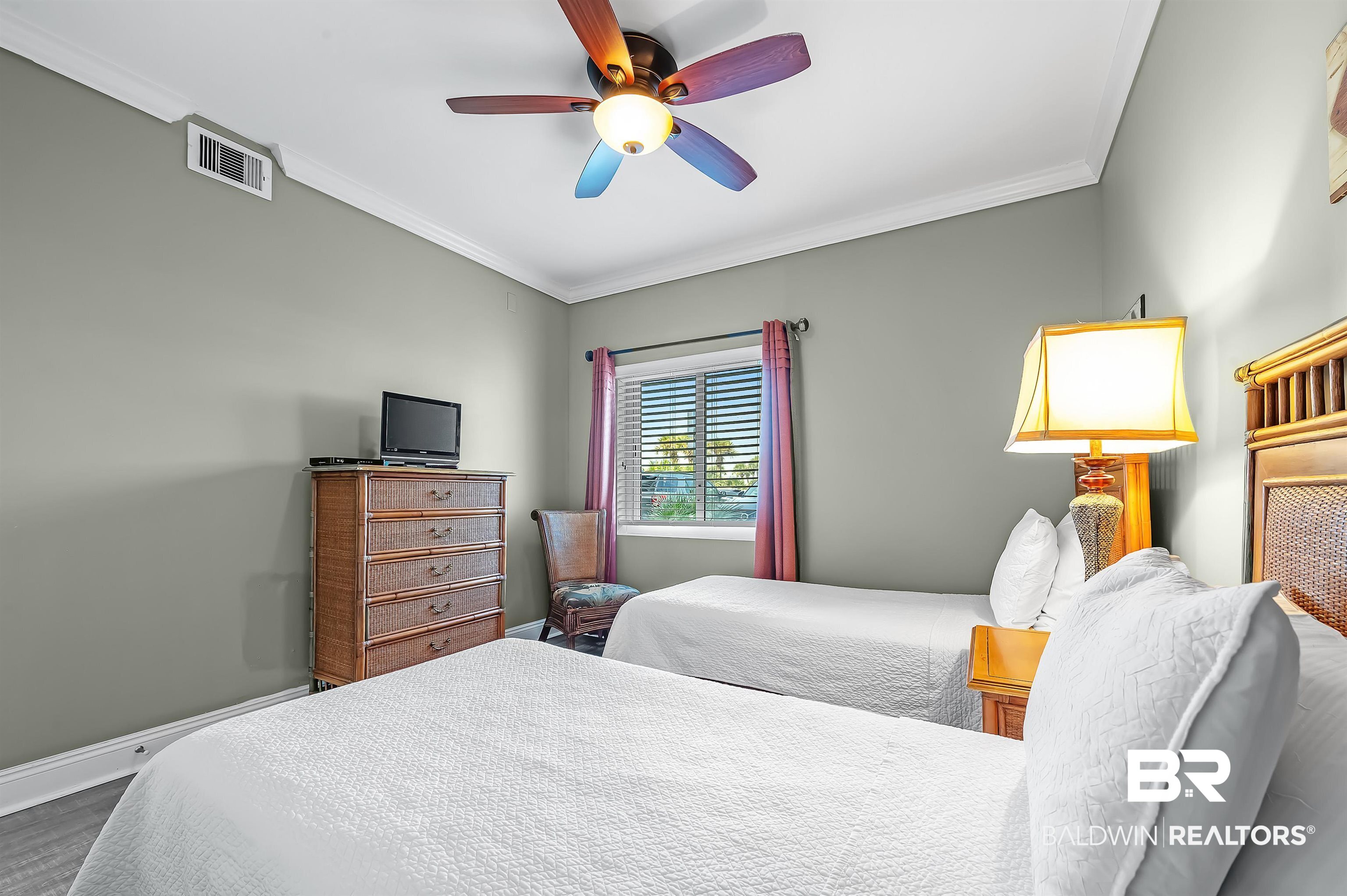 16287 Perdido Key Drive, Unit 105 Pensacola, FL 32507 - Photo 38 of 66 Neutral-toned room featuring crown molding and wood-finish flooring