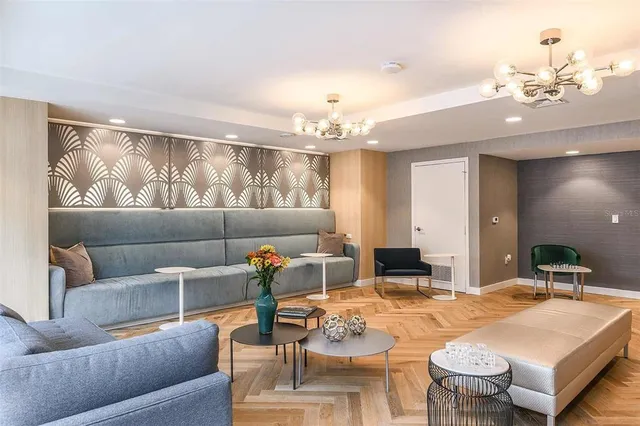 a living room with furniture and a chandelier