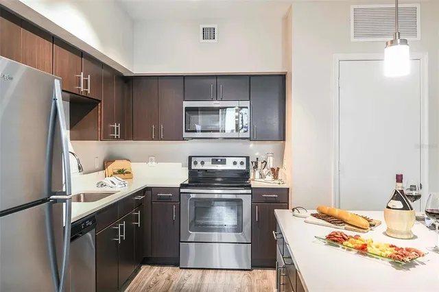 a kitchen with a sink and stainless steel appliances