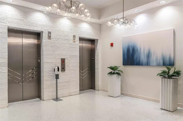 a view of a hallway with a chandelier