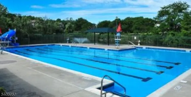 a view of a swimming pool with a yard