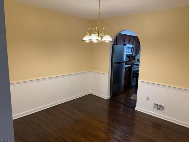 a view of a kitchen with wooden floor
