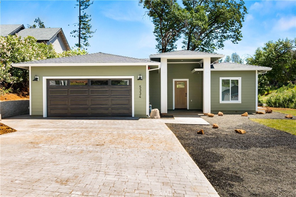 5334 Filbert Street Paradise, CA 95969 - Photo 1 of 30 a front view of a house with a yard and garage