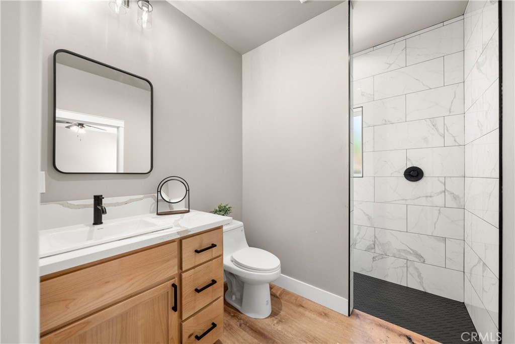 5334 Filbert Street Paradise, CA 95969 - Photo 18 of 30 a bathroom with a toilet sink a shower and vanity