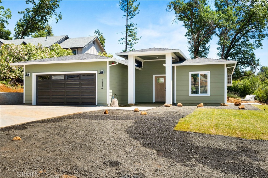 5334 Filbert Street Paradise, CA 95969 - Photo 2 of 30 a view of a house with backyard space and a garage
