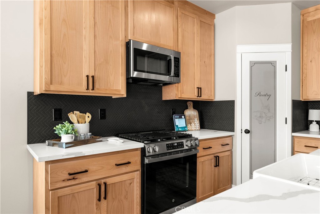 5334 Filbert Street Paradise, CA 95969 - Photo 10 of 30 a kitchen with stainless steel appliances granite countertop a sink a stove and a microwave