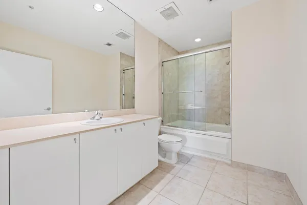 a bathroom with a double vanity sink toilet and shower