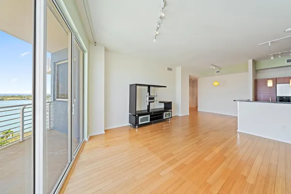a view of a room with wooden floor and furniture