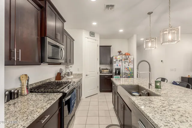 a kitchen with a stove a sink and a refrigerator