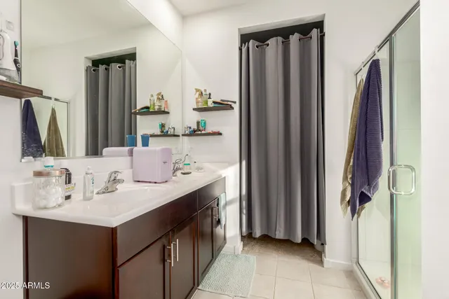 a bathroom with a double vanity sink and a mirror