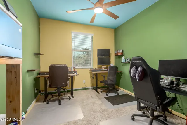 a view of a workspace with furniture and a window