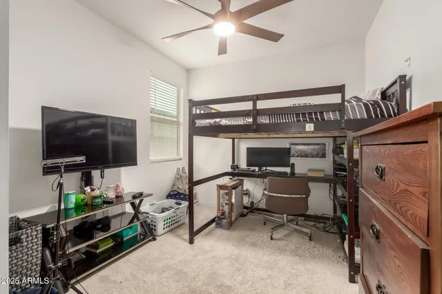 a view of a livingroom with workspace and a window