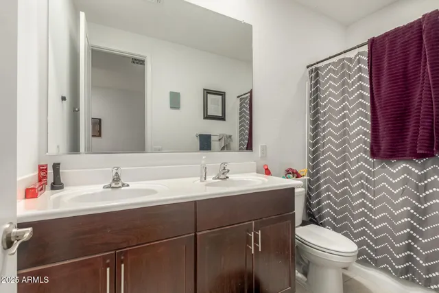 a bathroom with a sink toilet and mirror