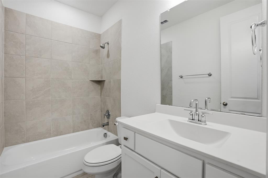 537 Oakmoss Street Little Elm, TX 76227 - Photo 22 of 39 a bathroom with a sink toilet and shower