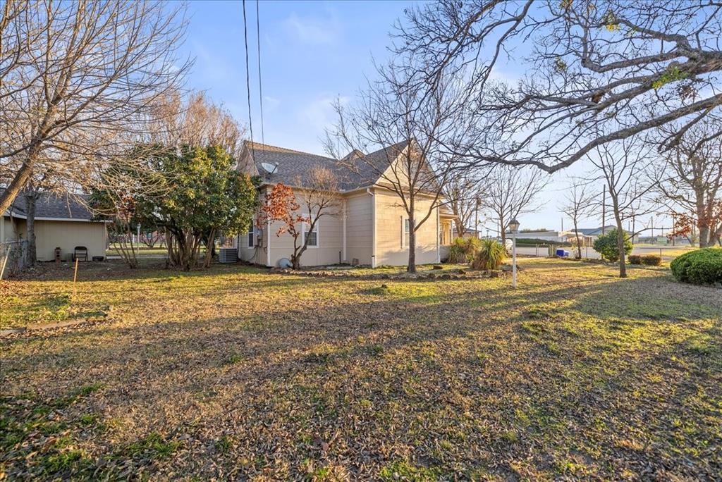 101 North 7th Street Krum, TX 76249 - Photo 25 of 26 View of property exterior with a lawn