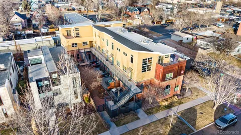 an aerial view of a residential apartment building with a yard