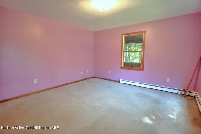 a room with a dresser and a window