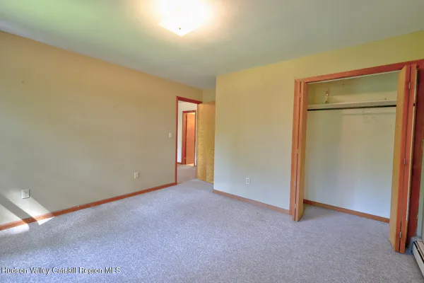 a bathroom with a granite countertop toilet sink and mirror