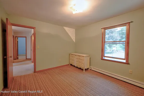 a bedroom with a bed and a mirror