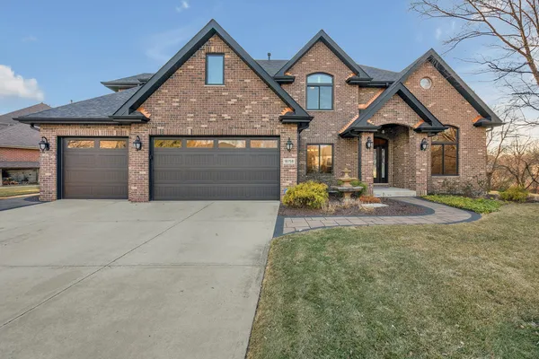 a front view of a house with a yard and garage