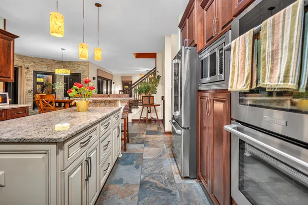 a kitchen with stainless steel appliances granite countertop a lot of counter space and a sink