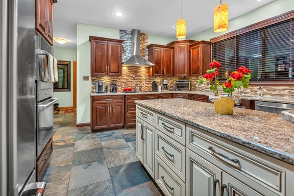 a kitchen with stainless steel appliances granite countertop a sink counter space cabinets and a counter top space