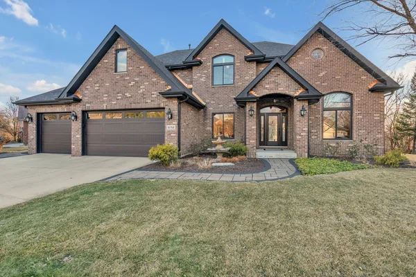 a front view of a house with a yard and garage