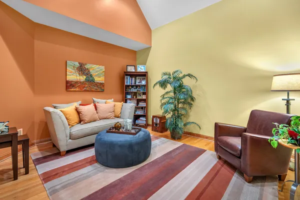 a living room with furniture and a potted plant