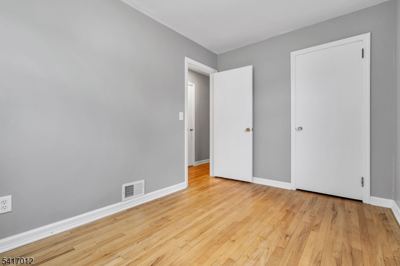 823 Pinewood Road Union, NJ 07083 - Photo 12 of 28 a view of an empty room with wooden floor