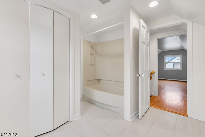 823 Pinewood Road Union, NJ 07083 - Photo 14 of 28 a bathroom with a bathtub and a shower