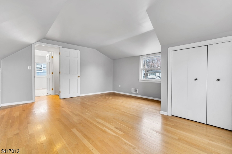 823 Pinewood Road Union, NJ 07083 - Photo 15 of 28 a view of an empty room with wooden floor and a window