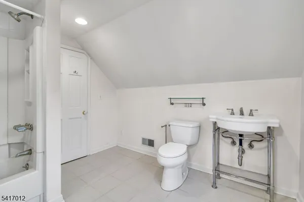a white toilet sitting next to a bathroom sink