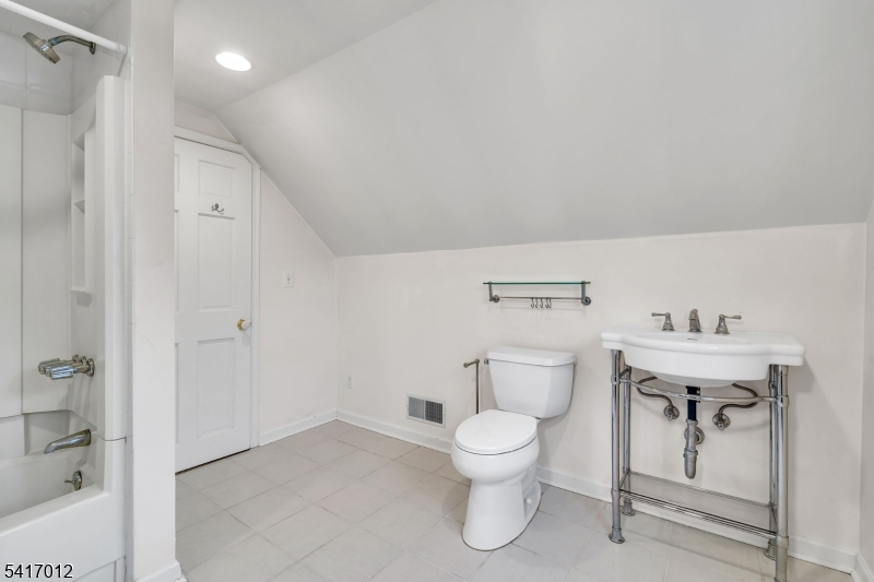 823 Pinewood Road Union, NJ 07083 - Photo 17 of 28 a white toilet sitting next to a bathroom sink