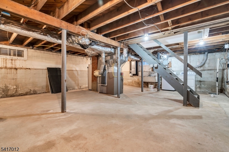 823 Pinewood Road Union, NJ 07083 - Photo 19 of 28 a view of an empty room with wooden stairs