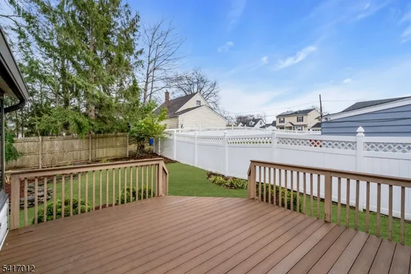a view of a deck with wooden floor and fence