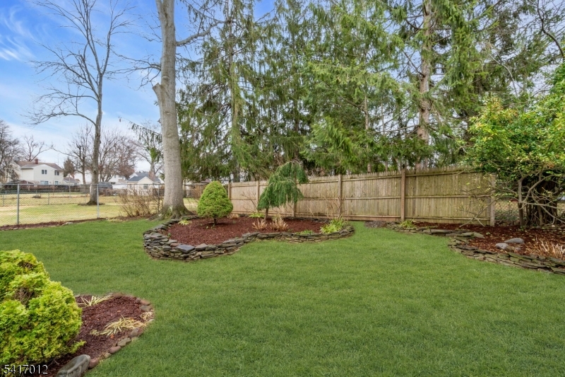 823 Pinewood Road Union, NJ 07083 - Photo 24 of 28 a view of a backyard with plants and a garden