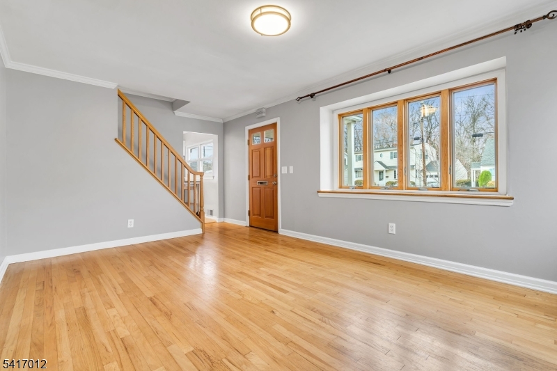 823 Pinewood Road Union, NJ 07083 - Photo 3 of 28 a view of an empty room with wooden floor and a window