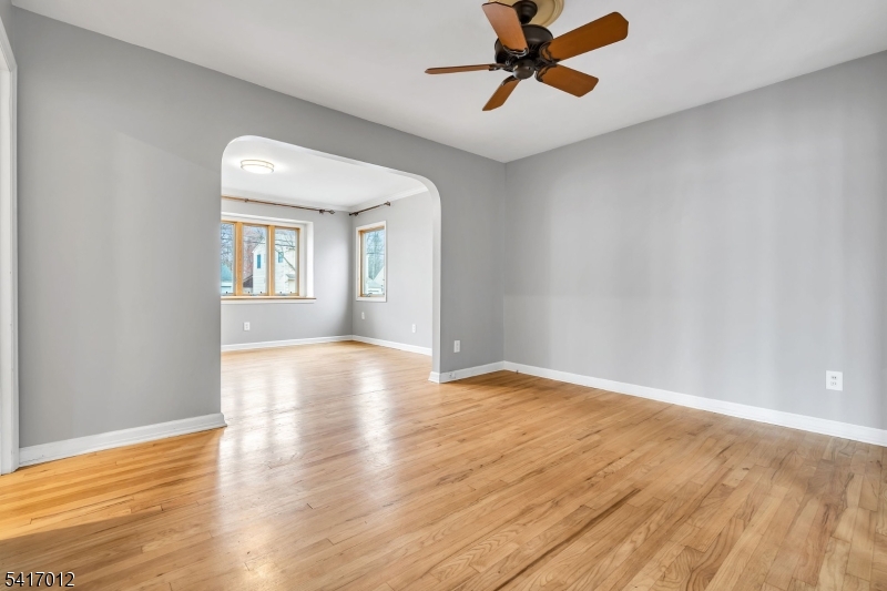 823 Pinewood Road Union, NJ 07083 - Photo 5 of 28 a view of empty room with wooden floor and fan