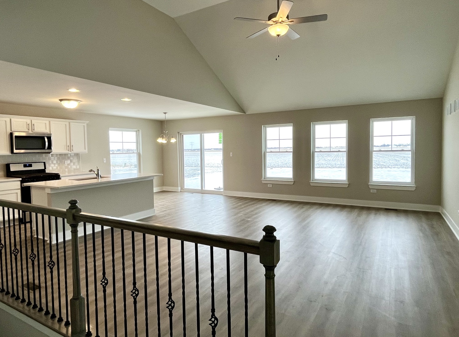 612 Stone Mill Drive Bourbonnais, IL 60914 - Photo 2 of 8 a view of a kitchen and an empty room with wooden floor and a window