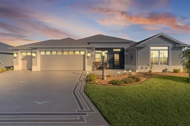 a view of a house with backyard and sitting area