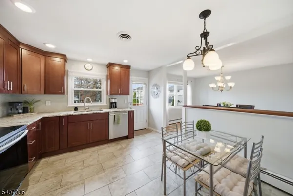 a kitchen with stainless steel appliances kitchen island granite countertop a sink and cabinets