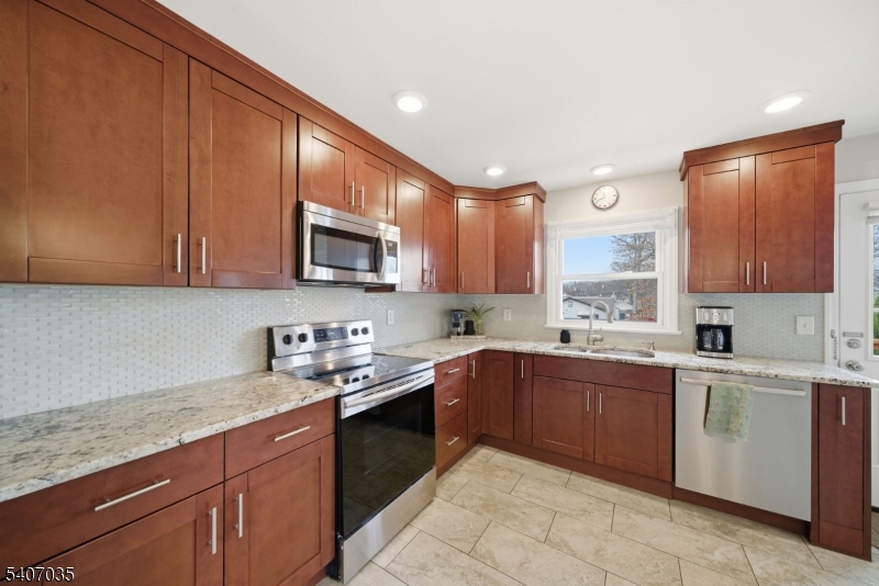 11 Deerfield Road Parsippany, NJ 07054 - Photo 12 of 42 a kitchen with lots of counter top space sink and cabinets
