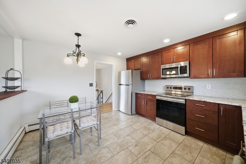11 Deerfield Road Parsippany, NJ 07054 - Photo 13 of 42 a kitchen with stainless steel appliances kitchen island granite countertop a sink and cabinets
